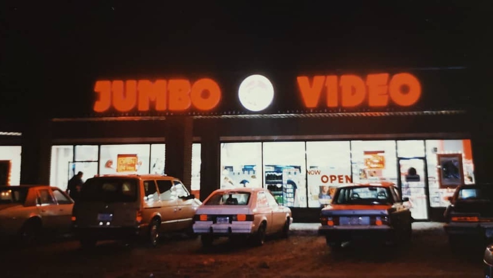 Store front of Jumbo Video at night.
